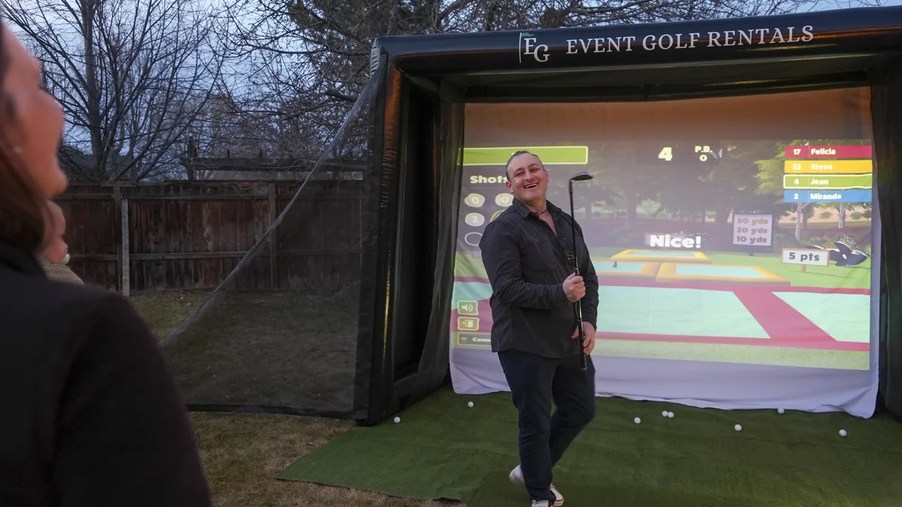 Player celebrating at outdoor golf simulator backyard party rental