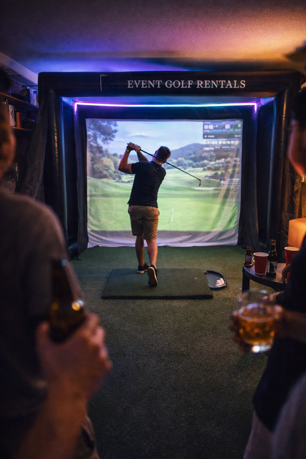 Golf simulator rental lit up for an evening party